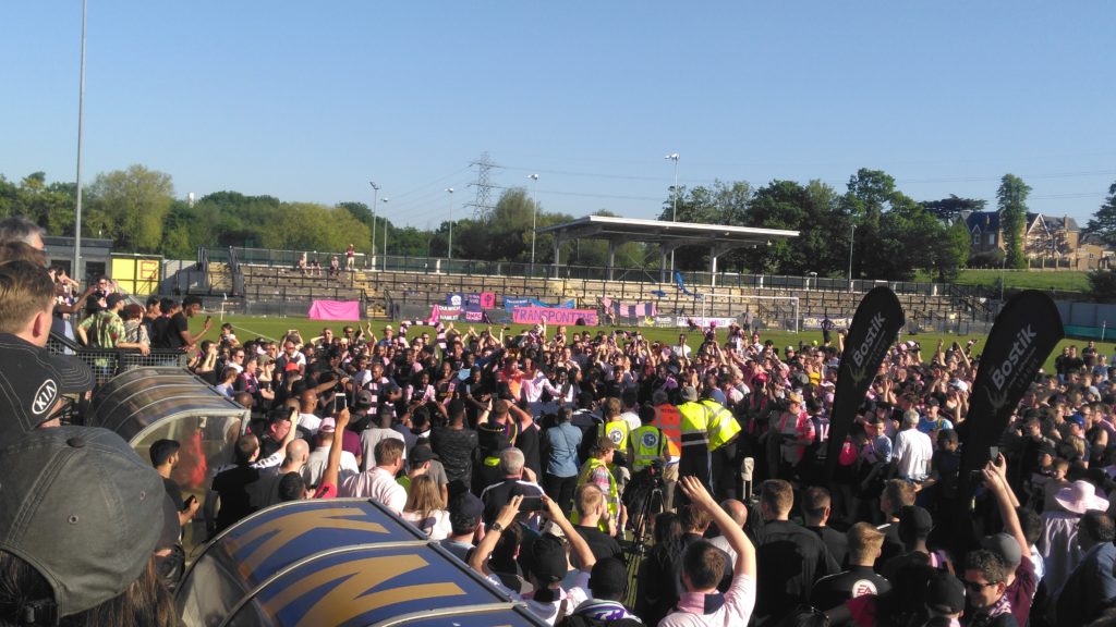 Dulwich fans celebrate promotion after winning the penalty shootout