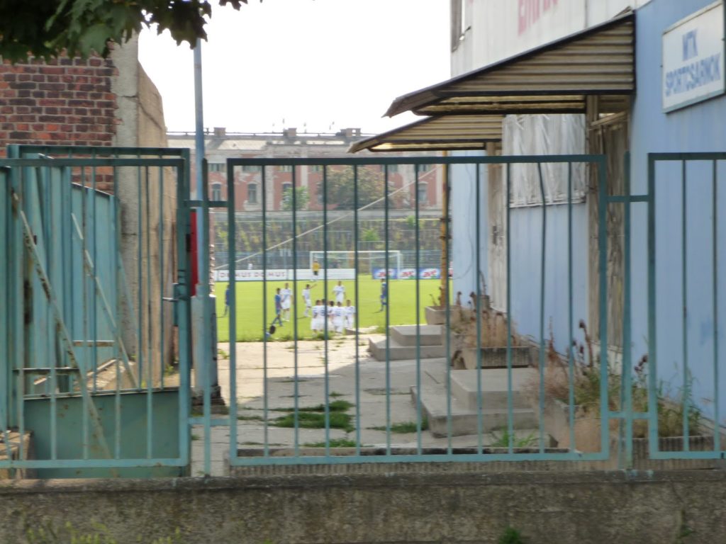 A match at the Hidegkuti Nandor Stadion viewed through railings from outside