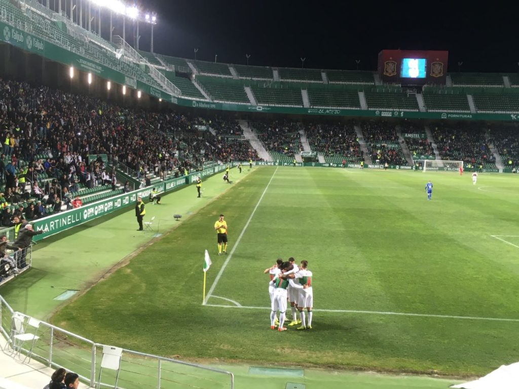 Elche players form a huddle after celebrating a goal