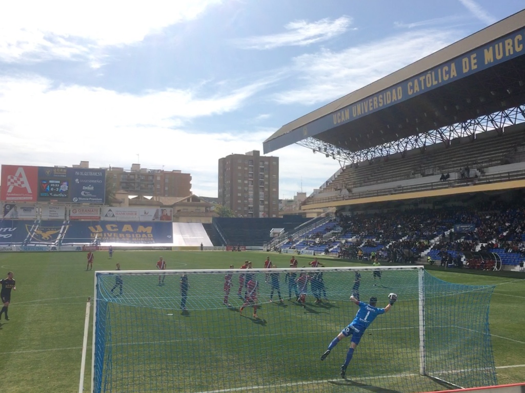 The UCAM Murcia goalkeeper makes a flying save from a free-kick