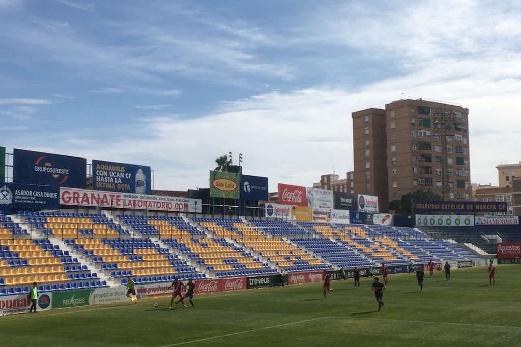 A Recreativo Huelva player is tackled near the touchline