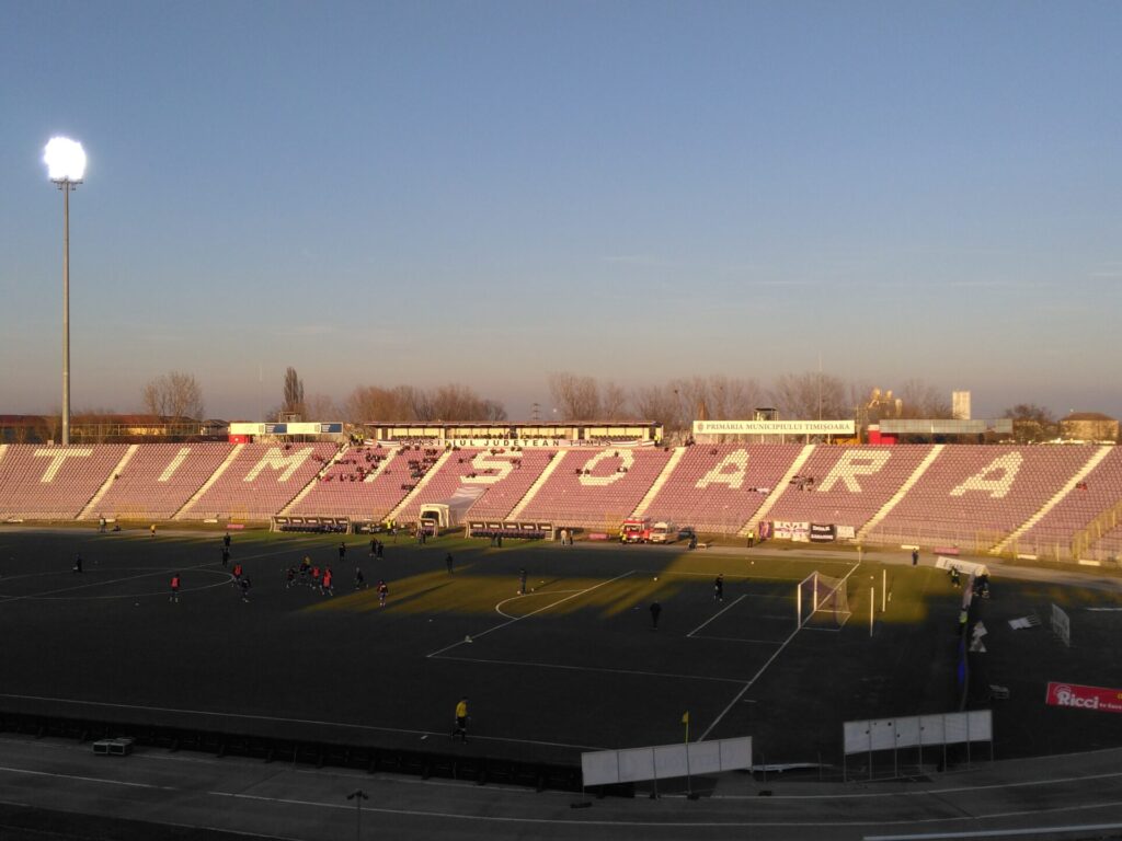 A curved football stand with seats spelling out Timisoara in capital letters